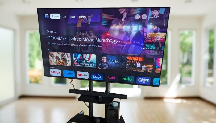 Modern TV side view, mounted above tiled floor area.