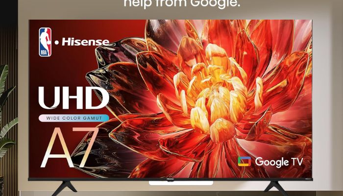 Smart TV with remote on table near sofa